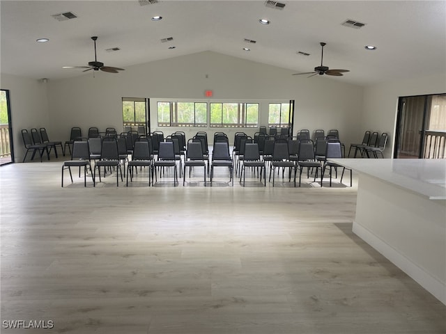 dining room featuring lofted ceiling and light wood-type flooring