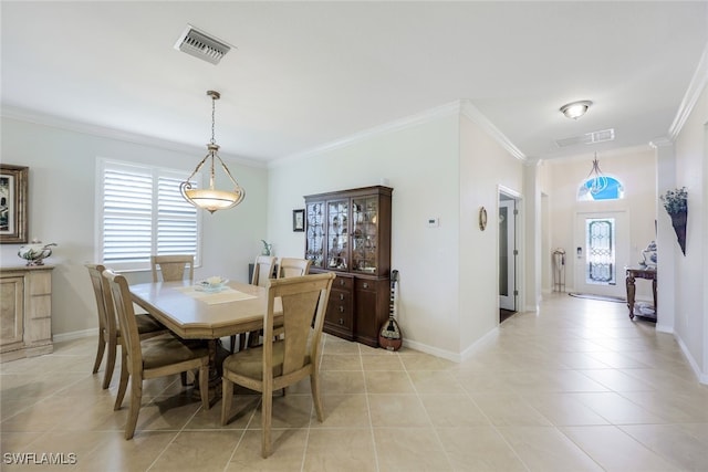 tiled dining area with a wealth of natural light and crown molding