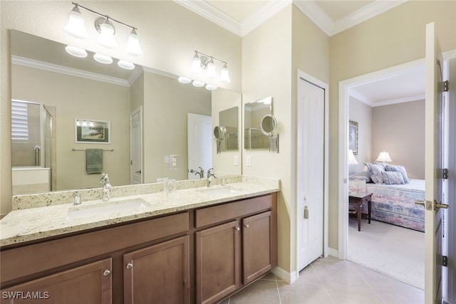 bathroom with tile patterned floors, vanity, a shower with door, and crown molding