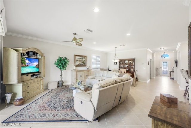 living room featuring light tile patterned floors, ceiling fan, and crown molding