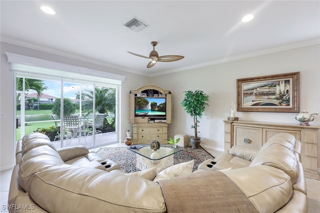 tiled living room with ceiling fan and crown molding