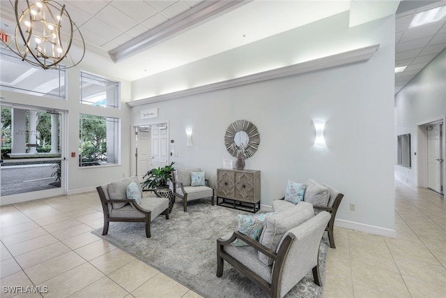 living room with light tile patterned floors, a towering ceiling, and an inviting chandelier