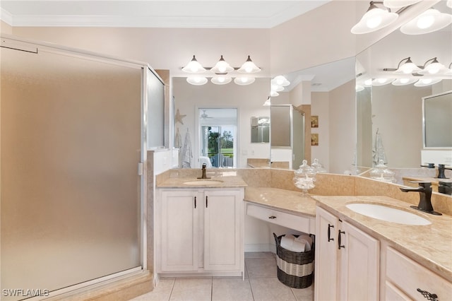 bathroom with an enclosed shower, vanity, tile patterned floors, and crown molding