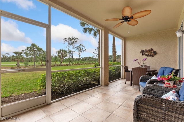 sunroom / solarium featuring ceiling fan