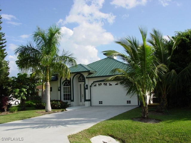 view of front of house with a front yard and a garage