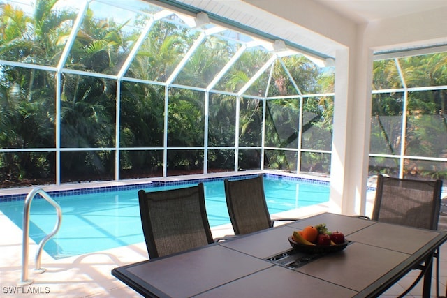 view of pool featuring a patio area and glass enclosure