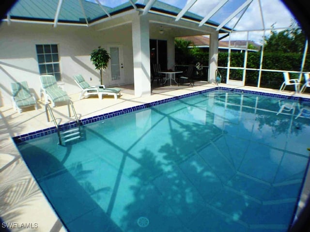 view of pool with a lanai and a patio area