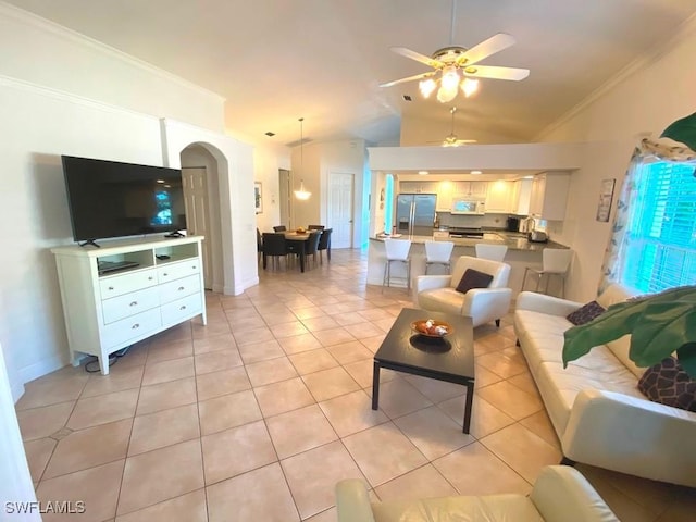 living room with light tile patterned floors, vaulted ceiling, ceiling fan, and crown molding