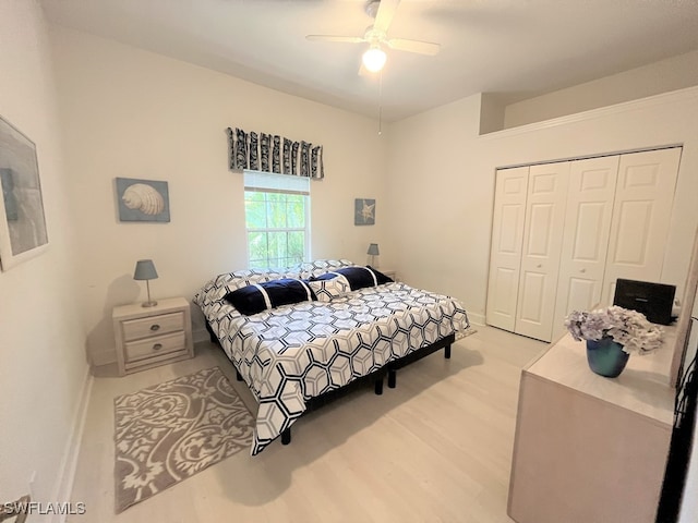 bedroom with ceiling fan, light hardwood / wood-style floors, and a closet