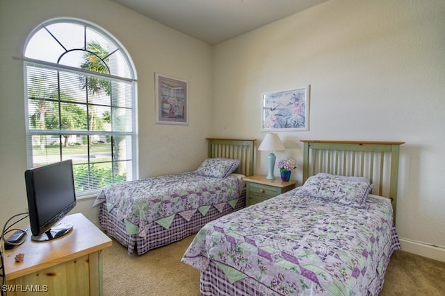 bedroom featuring light colored carpet