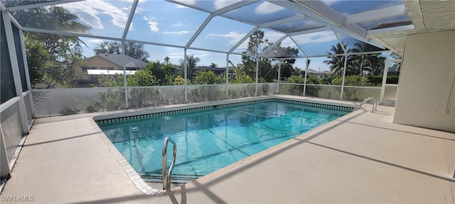 view of pool featuring glass enclosure and a patio area