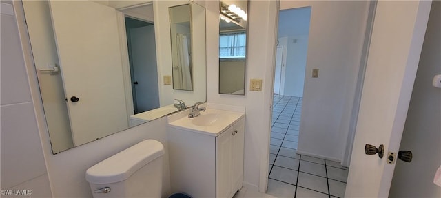 bathroom featuring toilet, vanity, and tile patterned floors