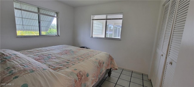 bedroom with multiple windows and light tile patterned flooring