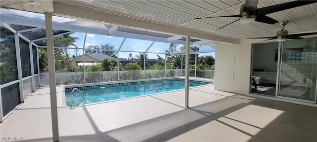 view of pool featuring a patio area, ceiling fan, and glass enclosure