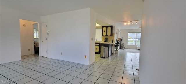 kitchen with a kitchen breakfast bar and light tile patterned flooring