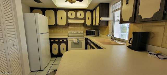 kitchen with light tile patterned floors, white appliances, tasteful backsplash, and sink