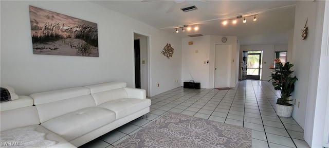 tiled living room featuring ceiling fan