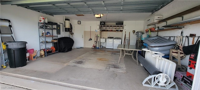 garage featuring washer and dryer and a garage door opener