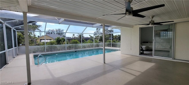 view of swimming pool featuring a lanai, a patio area, and ceiling fan