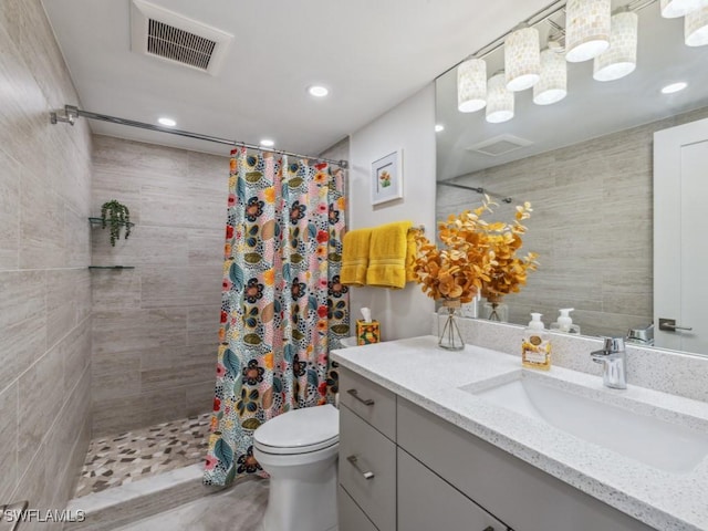 bathroom featuring vanity, toilet, and walk in shower