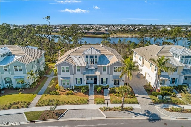 drone / aerial view with a residential view and a water view