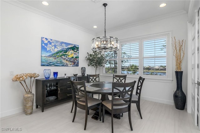 dining room featuring a chandelier, recessed lighting, baseboards, and ornamental molding