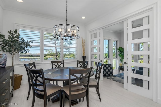 dining area featuring an inviting chandelier, recessed lighting, and ornamental molding