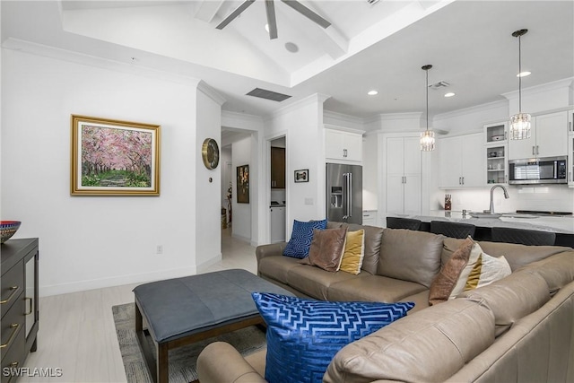 living room featuring ornamental molding, baseboards, visible vents, and ceiling fan