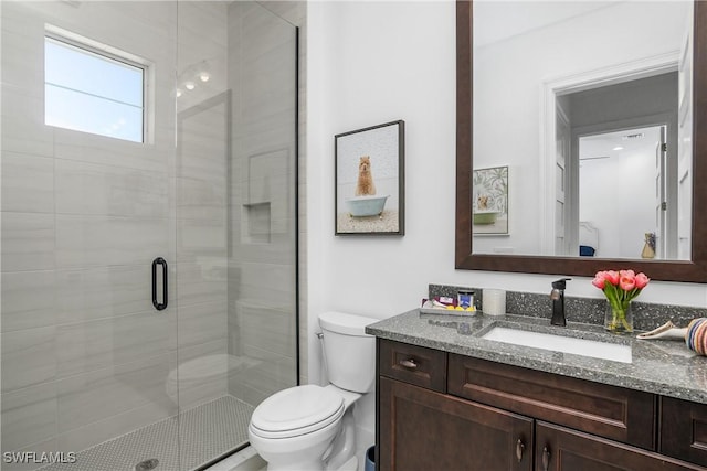 full bathroom with toilet, a shower stall, and vanity