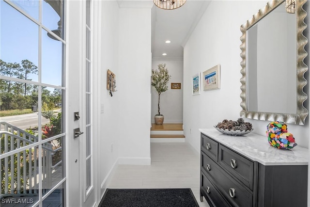 interior space with crown molding, recessed lighting, and baseboards