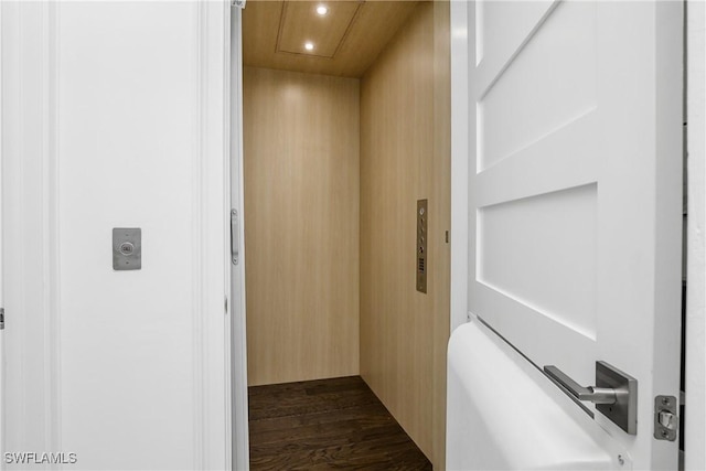 hallway featuring elevator, dark wood-style floors, and recessed lighting