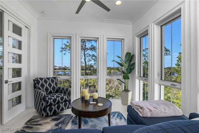 sunroom / solarium featuring a healthy amount of sunlight and ceiling fan