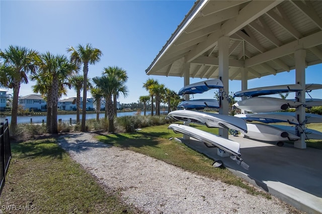 exterior space with gravel driveway and a water view