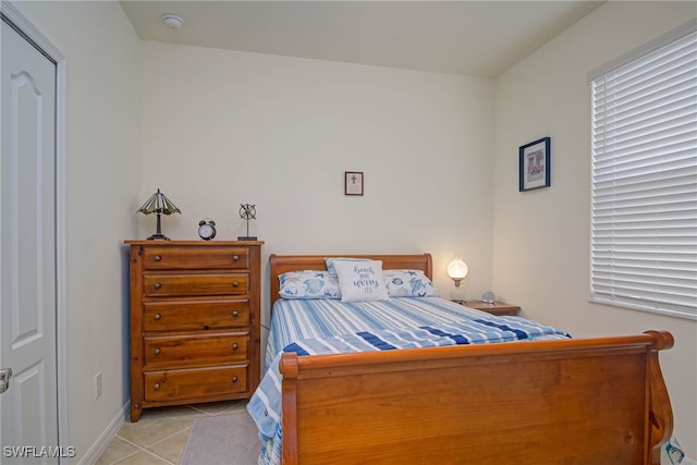 tiled bedroom with a baseboard heating unit