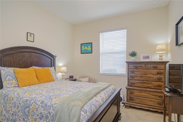 tiled bedroom featuring multiple windows