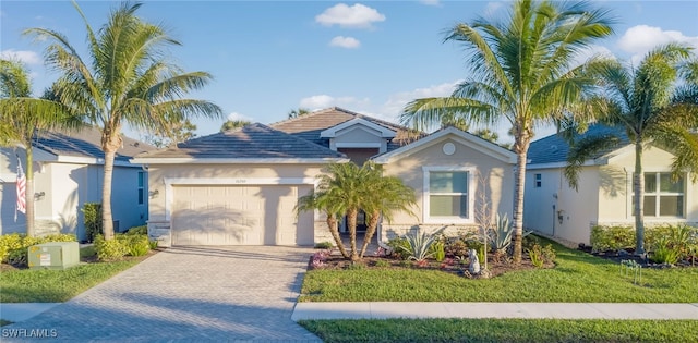 view of front of property with a front lawn and a garage