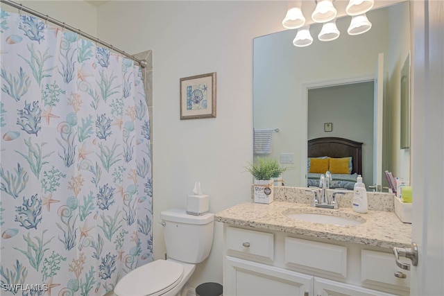 bathroom featuring walk in shower, vanity, and toilet