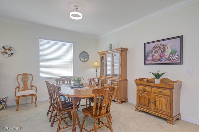 tiled dining room featuring crown molding