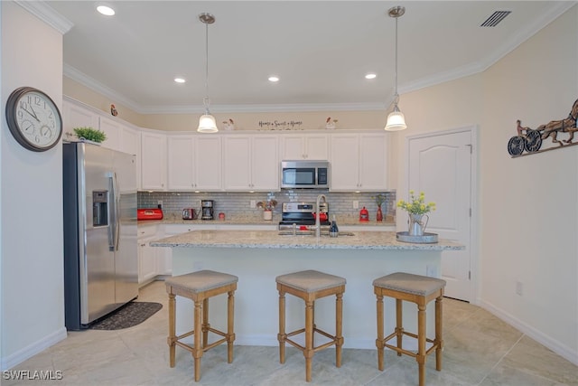 kitchen featuring white cabinets, appliances with stainless steel finishes, crown molding, and sink