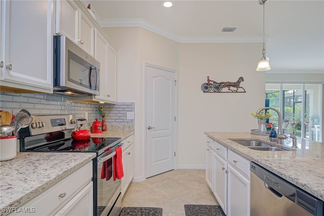 kitchen featuring light stone countertops, appliances with stainless steel finishes, sink, pendant lighting, and white cabinets