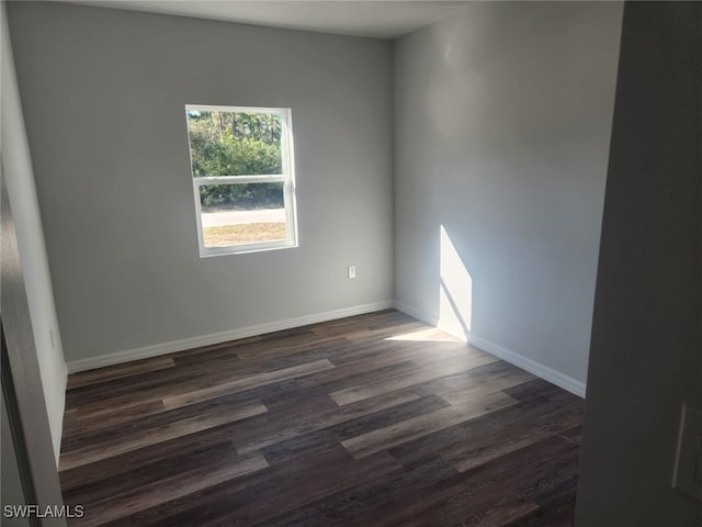 unfurnished room with dark hardwood / wood-style floors