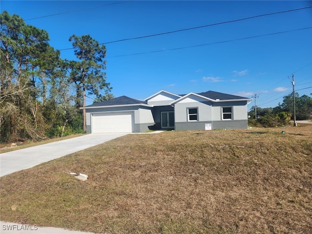 single story home featuring a garage and a front lawn