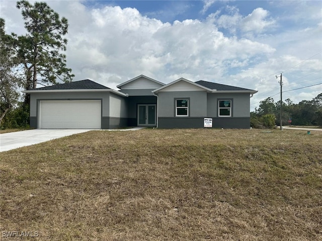 ranch-style home with a garage and a front yard