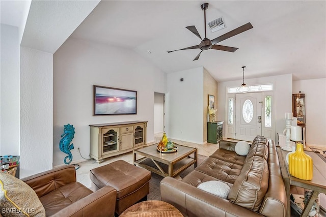 living room featuring ceiling fan, light tile patterned floors, and lofted ceiling