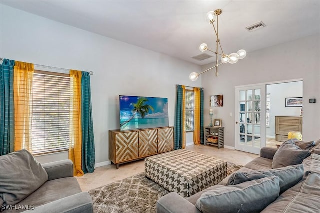 living room with a chandelier and french doors