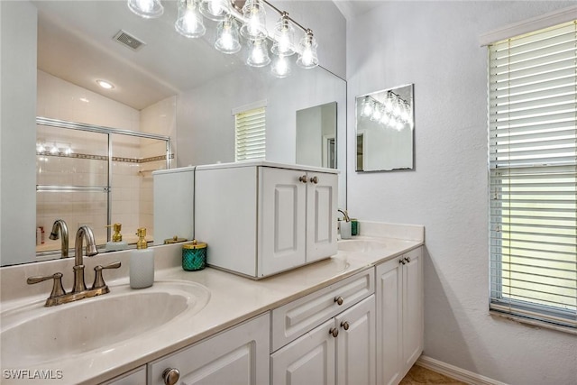 bathroom featuring plenty of natural light, a shower with door, vanity, and lofted ceiling