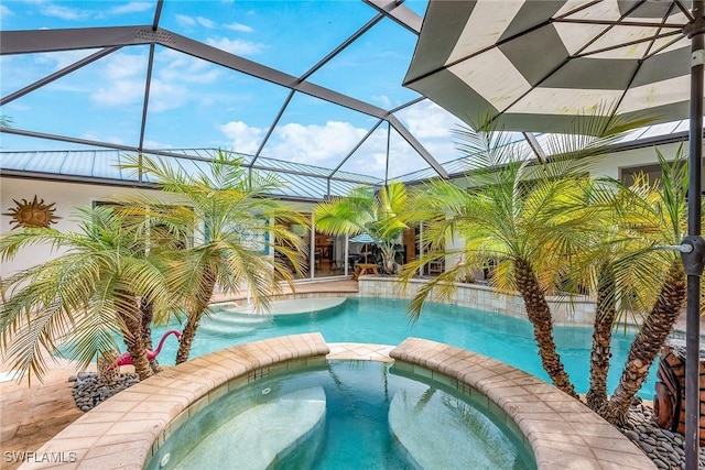 view of pool with an in ground hot tub, pool water feature, and glass enclosure