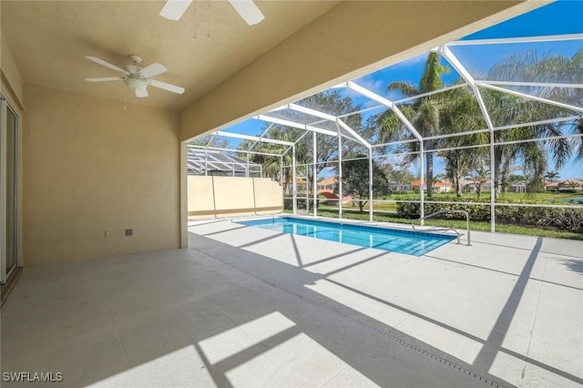 outdoor pool featuring a lanai, ceiling fan, and a patio area