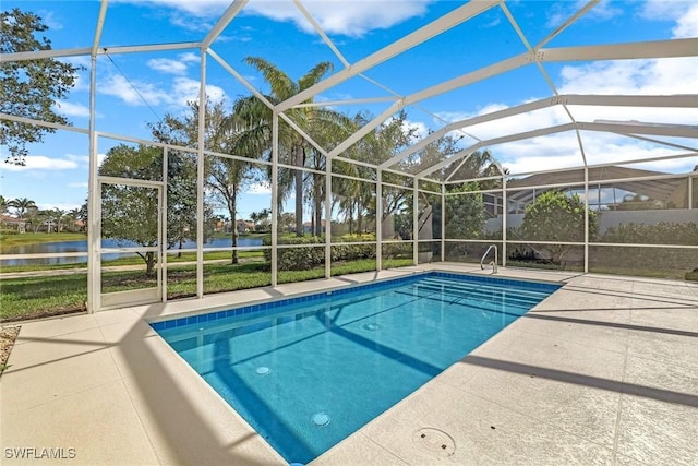 pool with a water view, a lanai, and a patio area