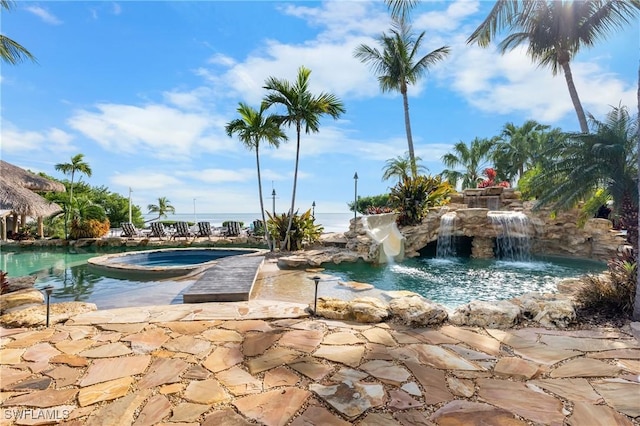 view of swimming pool featuring an in ground hot tub and pool water feature